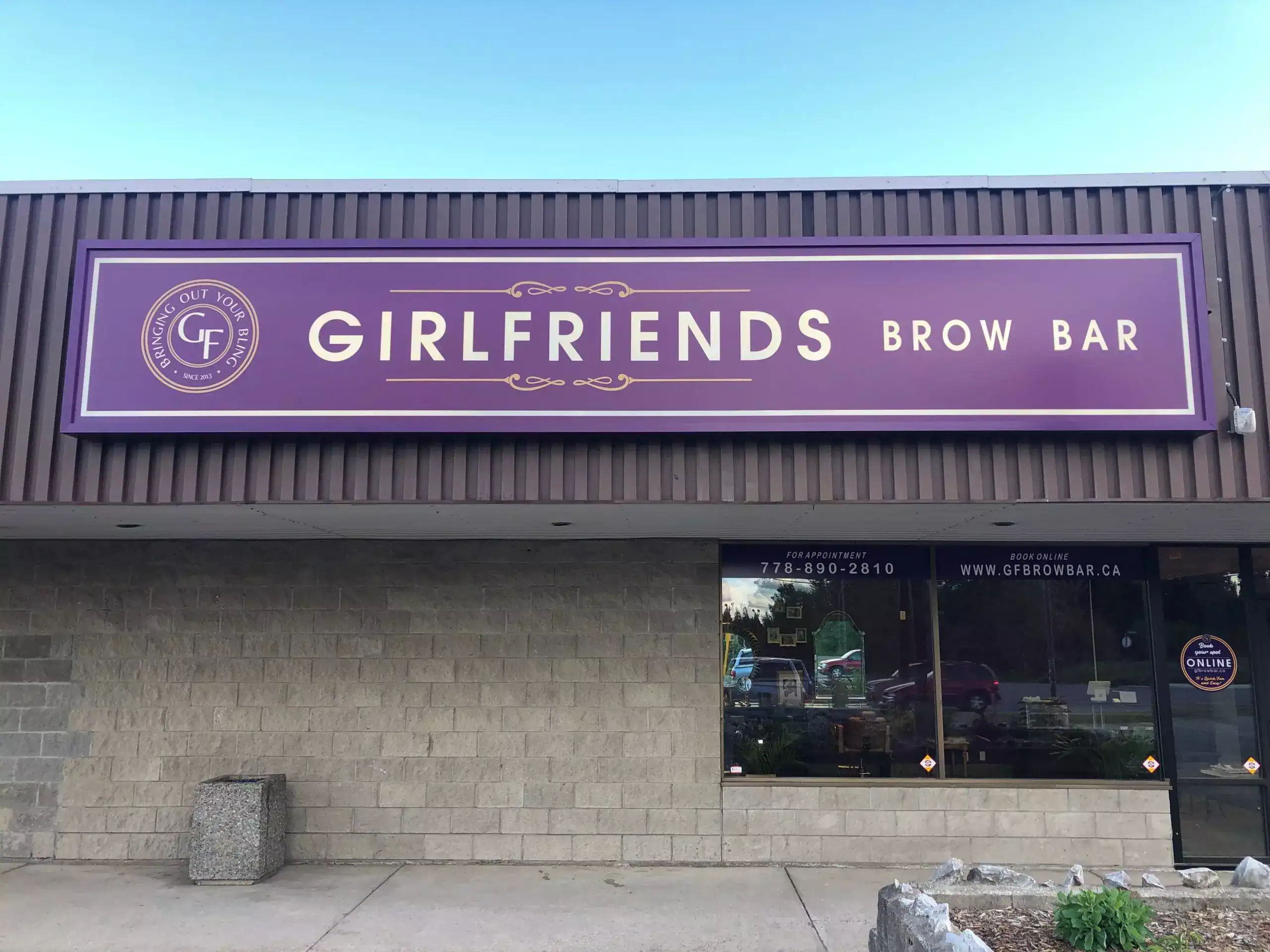 GFBrowBar Girlfriends Brow Bar storefront signage with purple background and white text in a commercial shopping area.